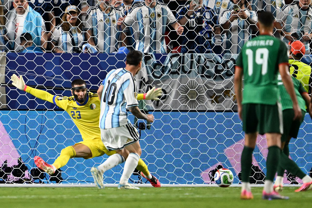 Argentina's forward #10 Lionel Messi shoots and scores his team's second goal during the 2026 World Cup Group J football match between Argentina and Algeria at the Kansas City Stadium in Kansas City on June 16, 2026.  