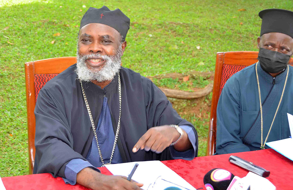 The Orthodox Archbishop, His Eminence Metropolitan Jeronymos Muzeeyi addressing the press as Fr. John Kibuuka Bbosa looks on at St. Nicholas Orthodox  Cathedral, Namungoona, in Kampala on March 2, 2022