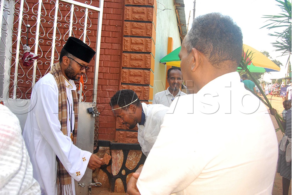 The Lead Priest Siyuman Binian (left) at Soya Medhananialem Ethiopian Orthodox church in Bbunga Makindye Division with believers during the Easter Celebrations on Saturday. (Credit: Benjamin Semwanga)