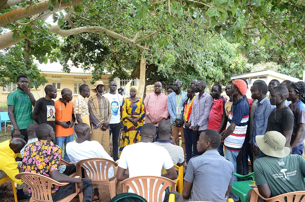 Balaam Barugahara (centre in checked shirt) the Minister of State for youth and children affairs and minister Hudah Olero (yellow dress) the minister for state for veteran affairs pose for a picture with some of the youth that joined the Natioanl Resistance Movement from the opposition political parties. This was during during a minister Barugahara’s Youth Wake Up Call Mobilisation and Accountability tours in West Nile. This was at Yumbe district offices on October 15, 2025. (Credit: Lawrence Mulondo)