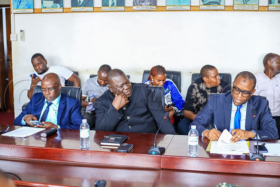 Nelson Mandela National Stadium Managing Director Jamil Ssewanyana (right) signs the MOU as NCS General Secretary Dr. Patrick Bernard Ogwel (centre) looks on. Photo by Fred Kisekka