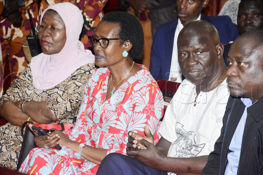 L-R; Hajji Obed Lutale's wife, Winnie Byanyima, wife to Dr Kiiza Besigye and Wafula Ogutu in court on Tuesday
