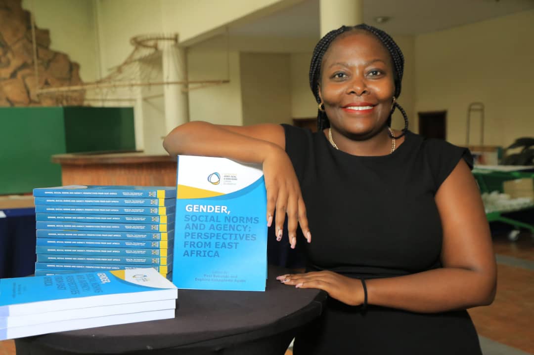 Dr Daphine Kabagambe Agaba, a Makerere University lecturer and one of the co-editors of the book titled Gender, Social Norms and Agency: Perspectives from East Africa, displays the book at Golf Course Hotel on Wednesday evening. (Courtesy)