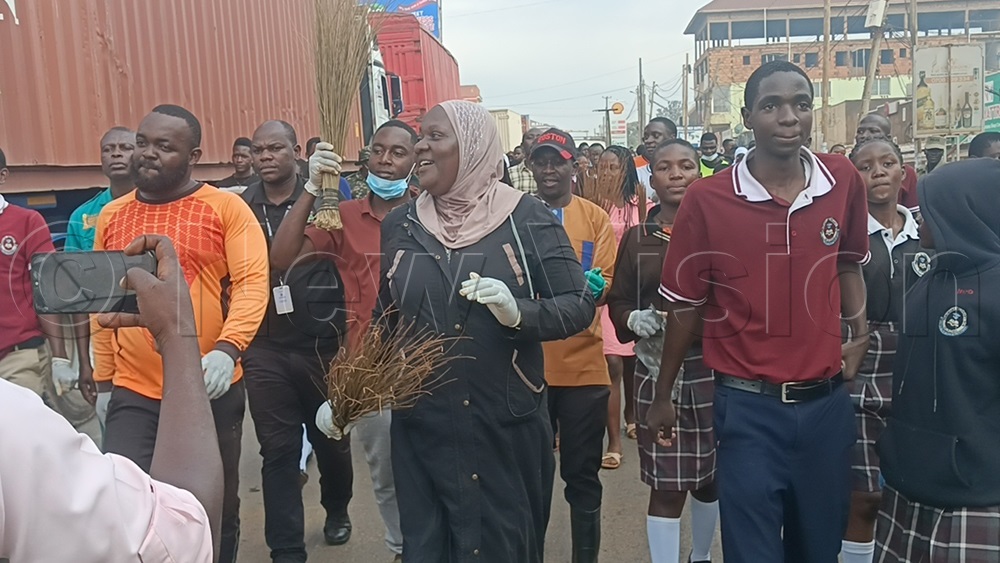 Mukono Resident District Commissioner (RDC) Hajjati Fatumah Ndisaba leads the district's general cleaning campaign during Uganda's National Cleaning Day. (Photo by Eric Yiga)