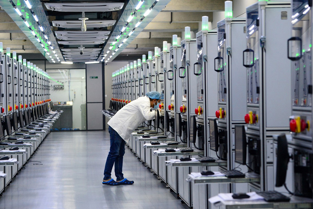 A laboratory technician monitoring the progress of lab-grown diamond seeds at Greenlab Diamonds manufacturing firm on the outskirts of Surat. (Photo by Sam PANTHAKY / AFP)