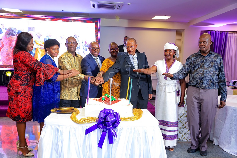 DCJ Flavian Zeija, PJ Jane Frances Abodo and PS Pius Bigirimana cutting the cake with the retired judicial officers at the Supreme Court hall on Tuesday. (Photo by Farooq Kasule)