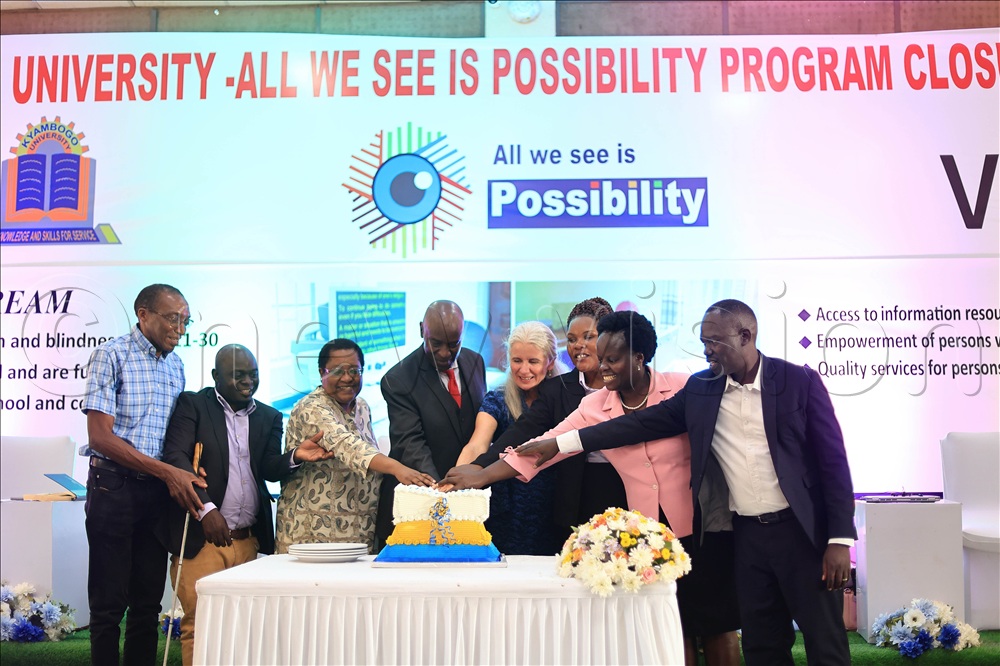 Officials from All We See is Possibility and Kyambogo University cutting cake during the program closure event.