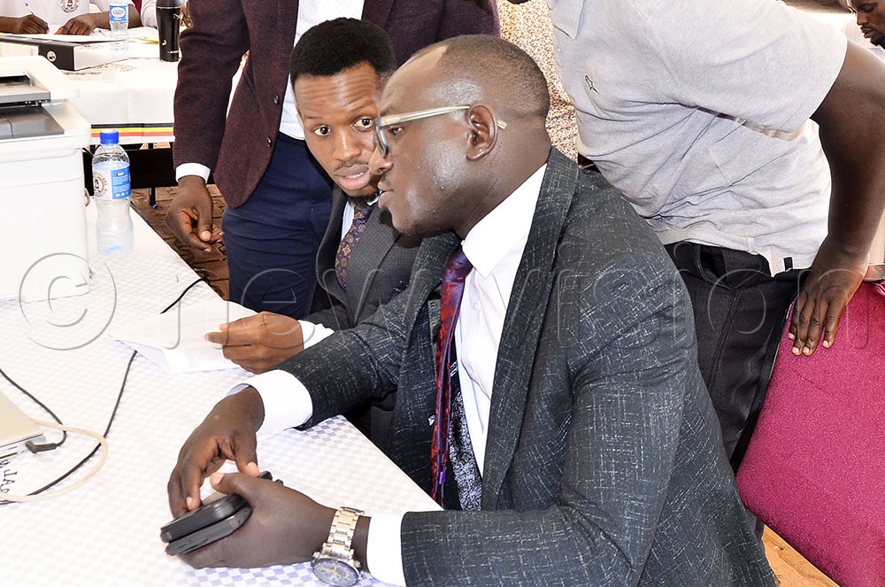 A presidential aspirant from Victoria University, Alvin Mivule Alvin (left) consulting Vuni Ronald during the submission of signatures for nomination at the Electoral Commission office in Kampala on 15 September 2025. (Photo by Ronnie Kijjambu)