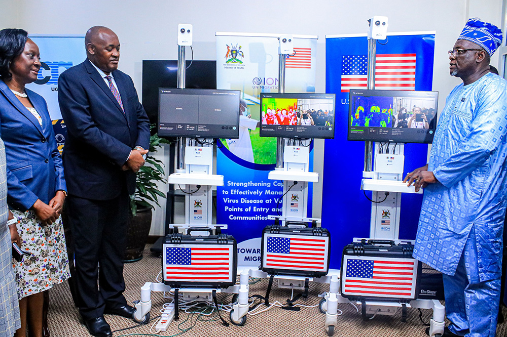 International Organization for Migration (IOM)'s Chief of Mission in Uganda Sanusi Tejan delivering to Dr. Chris Baryomunsi, the Minister of Health, a consignment worth sh755m to enhance public health surveillance and early outbreak detection. (Courtesy)
