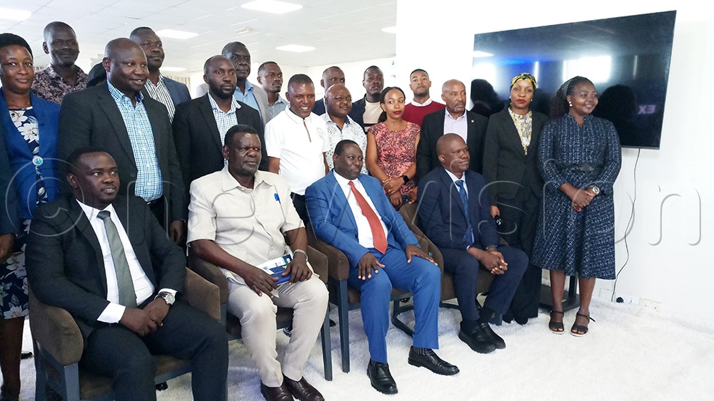 The Commissioner for Processing and Marketing at the Ministry of Trade, Joshua Mutambi (wearing a red tie), the acting chairman of KACITA, Issa Ssekito (seated second left), and Samson Ssemakalu (seated second left) pose for a group photo with participants during the dissemination of business climate index findings at Skyz Hotel in Kampala. (Photo by Francis Emorut)