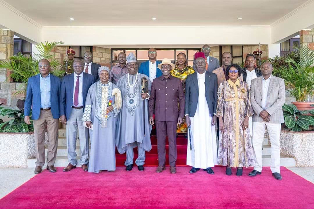 President Ruto and Iteso Paramount Chief Paul Sande Emolot in a group photo.