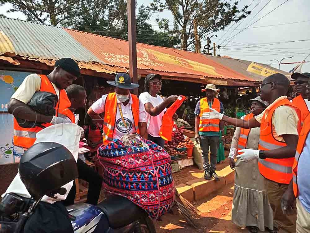 Members of Rotary Club of Lubowa interacting after cleaning exercise at Zana market along Entebbe Road in Wakiso district. (Credit: Francis Emorut)