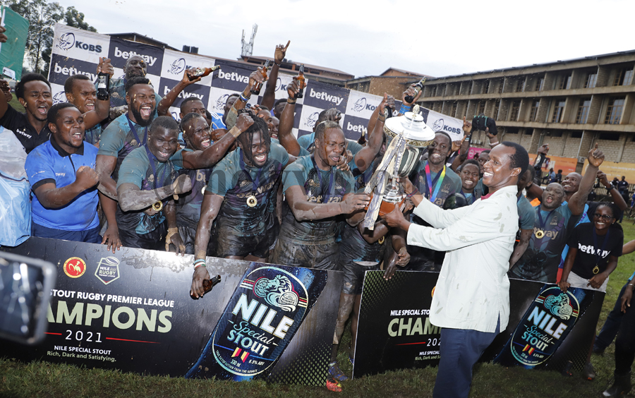 Prince David Wasajja hands over the Nile Special Stout Premier Rugby League trophy to Kobs