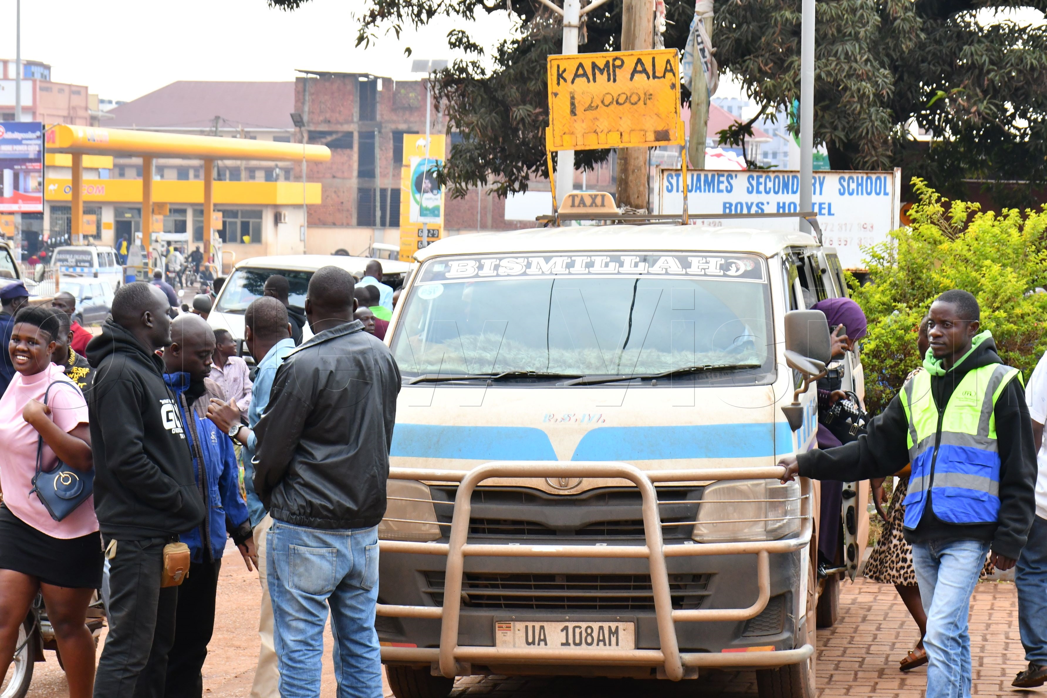 A Kampala-bound taxi loads passengers at Kiyembe C Stage in Jinja City before a clash with Jinja City law enforcement officers on Wednesday. (Photo by Donald Kiirya)