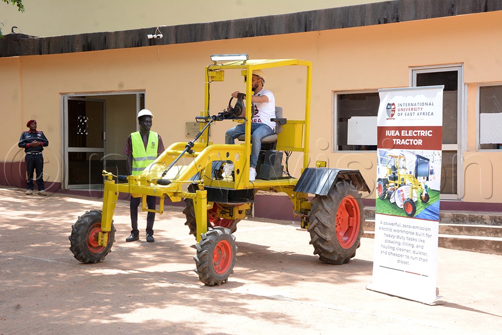 A student testing an electric tractor at the International University of East Africa (IUEA). The tractor is a powerful zero-emission electric workhorse built for heavy-duty tasks. (Photo by Mary Kansiime)