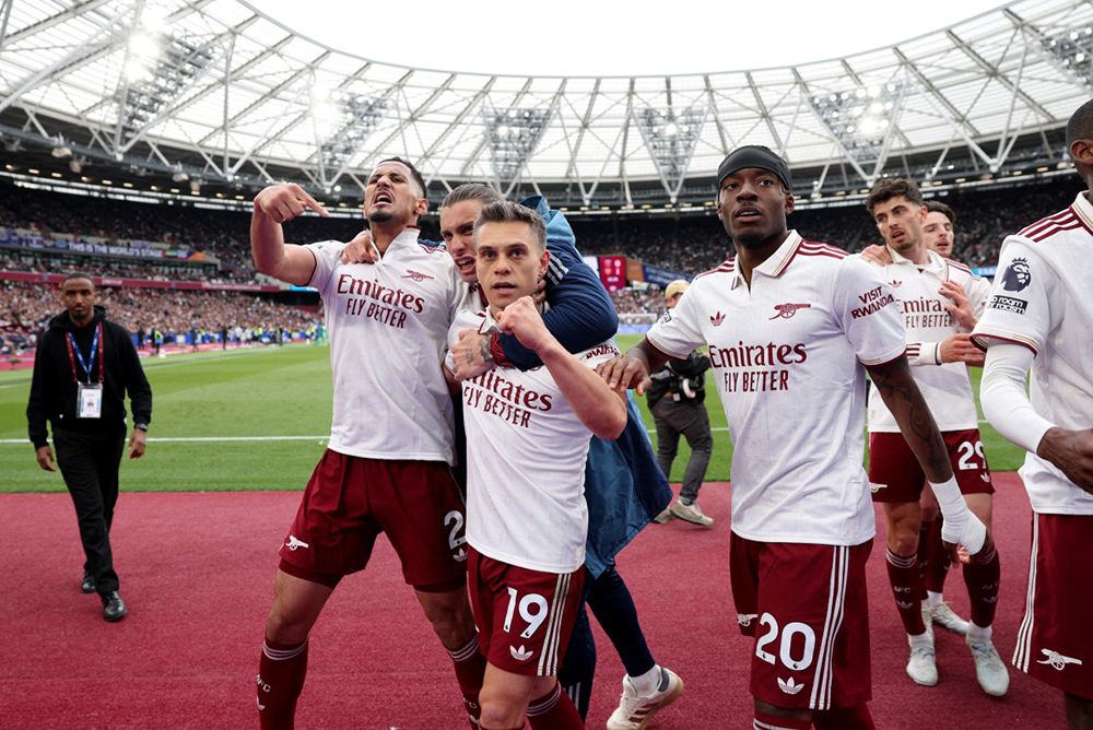 Arsenal's Belgian midfielder #19 Leandro Trossard celebrates scoring the team's first goal during the English Premier League football match between West Ham United and Arsenal at the London Stadium, in east London on May 10, 2026. 
