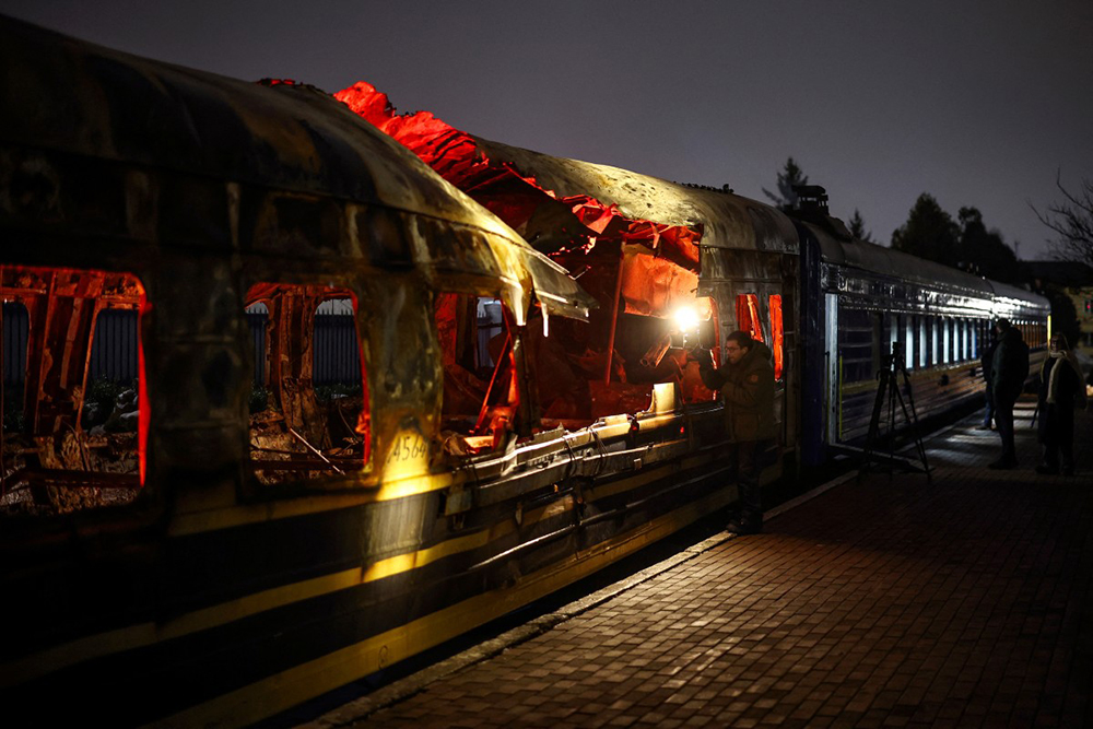 Members of the media view a Ukrainian railway carriage that was attacked by a Russian drone on January 27, 2026 near Kharkiv in eastern Ukraine killing six people, on display at the Kyiv central train station on February 23, 2026, ahead of the fourth anniversary of Russia's invasion of Ukraine. (Credit: AFP)