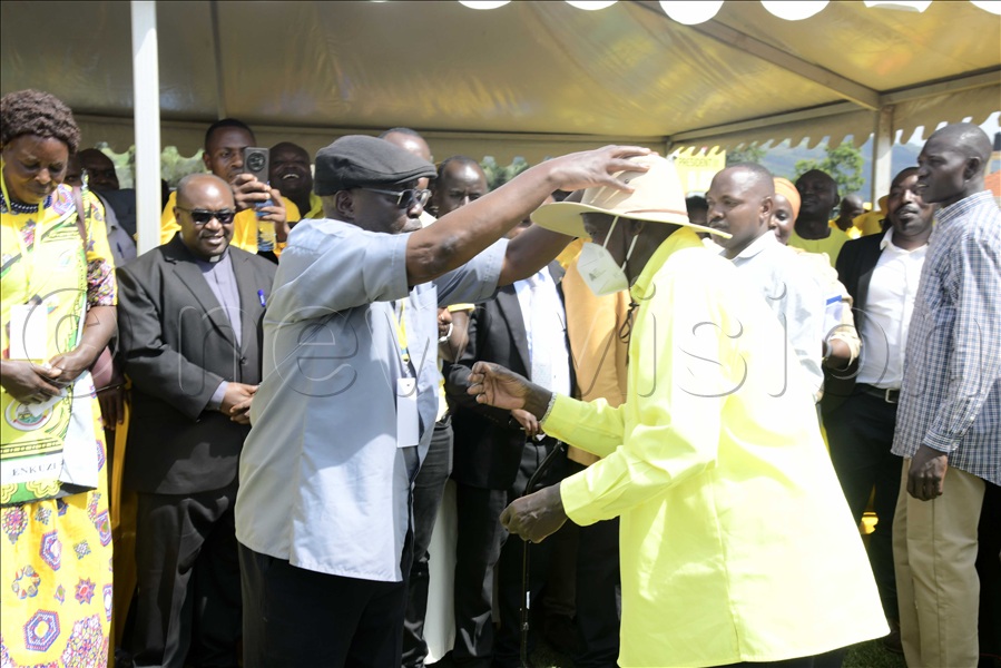 Fr. Gaetano Batanyenda praying for President Yoweri Museveni.