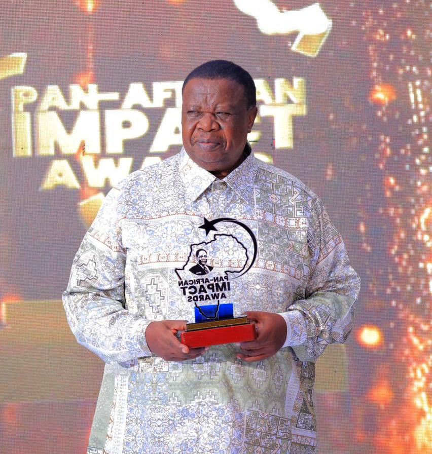 The Minister of Internal Affairs, Gen Kahinda Otafiire, holds an award before he handed it over to one of the winners during the Pan African Impact Awards and Royal Banquet on Saturday, May 23, 2026. 