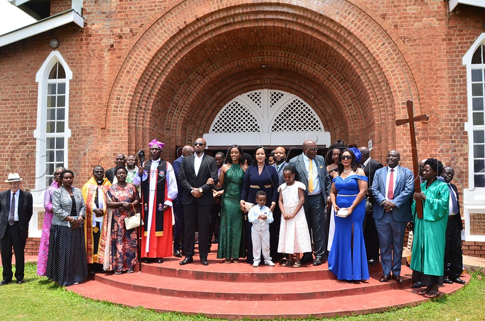 Members of the Royal family led by King Oyo (in glasses) together with the young prince and the bishop after baptism. (Credit: Jonan Tusingwire)