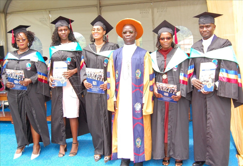 The Vice-Chancellor of UniK, Bro. Deogratias  Mugema (fourth-left) shares  a photo-moment with some of the graduands who performed exceptionally well. This was during the university's 11th Graduation ceremony at  Kisubi on Entebbe Road, in Wakiso district on Friday, October 23, 2026.