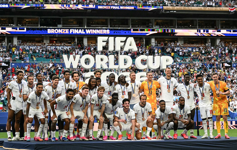 England's players pose for a photo with their medals after winning the 2026 World Cup football tournament third-place match between France and England at the Miami Stadium in Miami on July 18, 2026. (Photo by CHANDAN KHANNA / AFP)