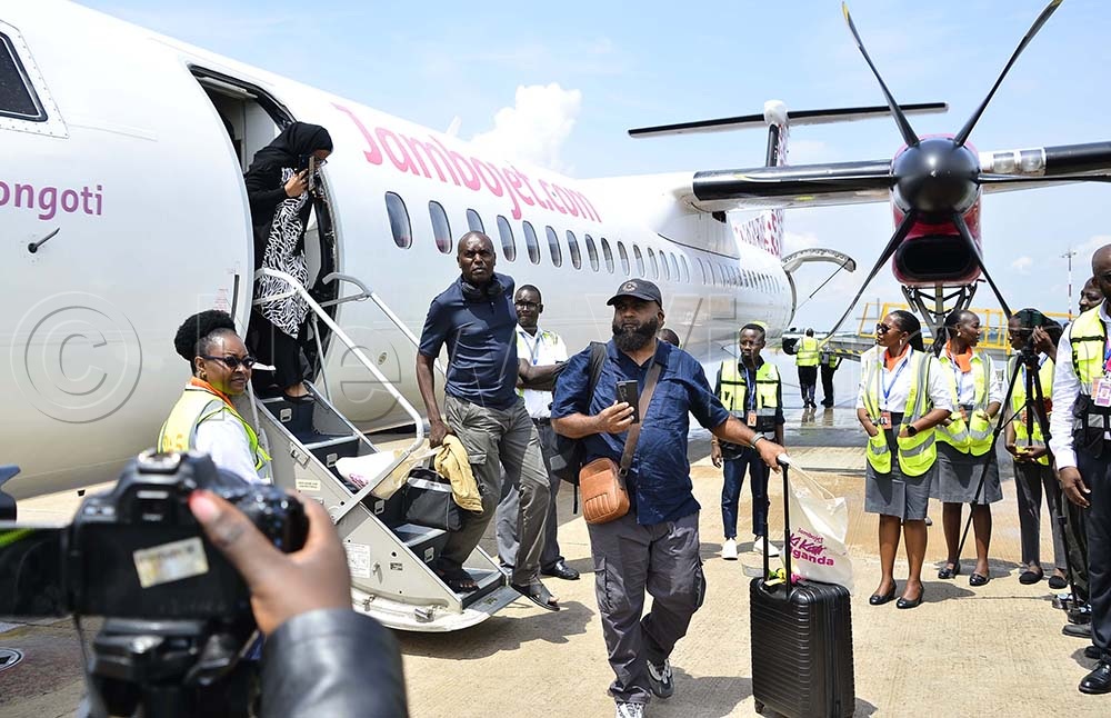 Passengers leaving the plane as airlines officials look on during the launch at Entebbe International Airport on 1st October 2026. (Credit: Juliet Kasirye)