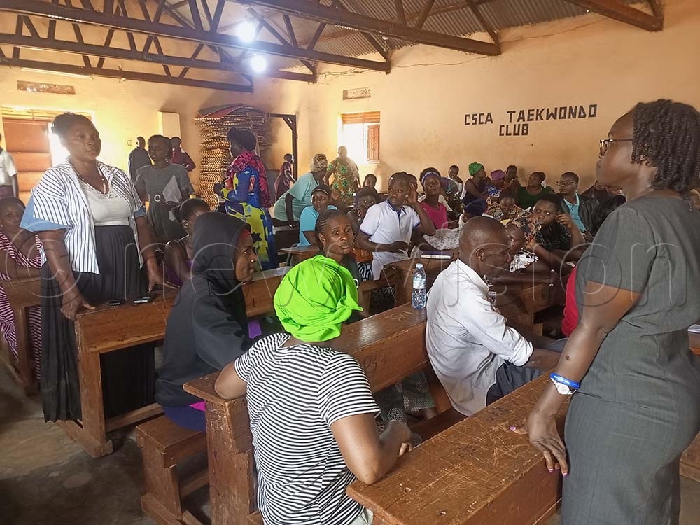 Parents share feedback and testimonies with TMF and DREAMS officers at Kireka Army Primary School. (Credit: Jacky Achan)