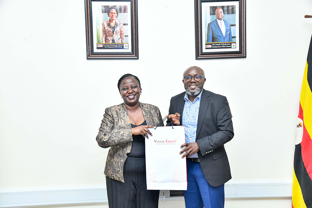 Vision Group Chief Executive Officer, Don Wanyama (right) presenting a package to National Identification and Registration Authority (NIRA) Executive Director Rosemary Kisembo (left). (Courtesy)