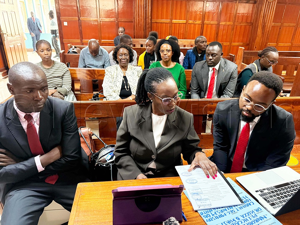 Ugandan lawyer Male Mabirizi, Besigye's lead counsel Martha Karua and another lawyer perusing files of Besigye's case at Mulimani High Court in Kenya during the mention of Besigye's case on Monday, September 29, 2025. (Photo by Isaac Nuwagaba)