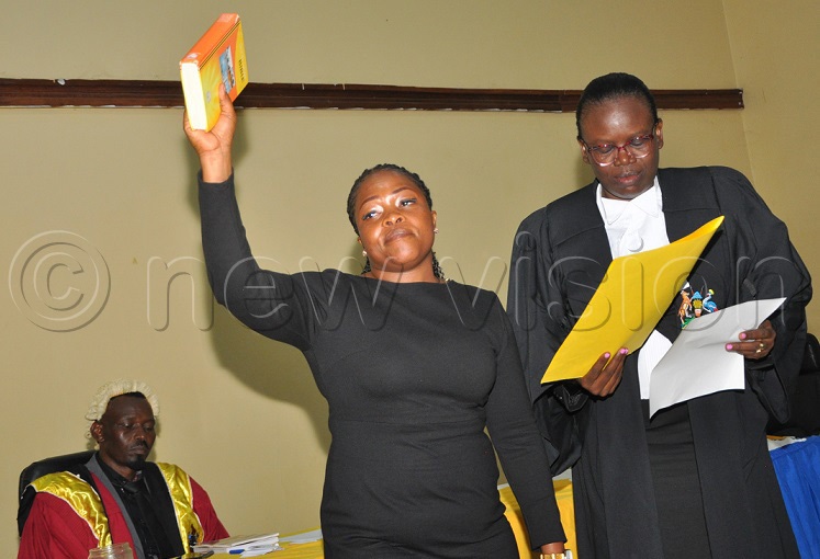 Daphane Kayizuka the deputy speaker taking oath before the Jinja Chief Magistrate Phiona Angura at the council chambers. (Photo by Doreen Musingo)