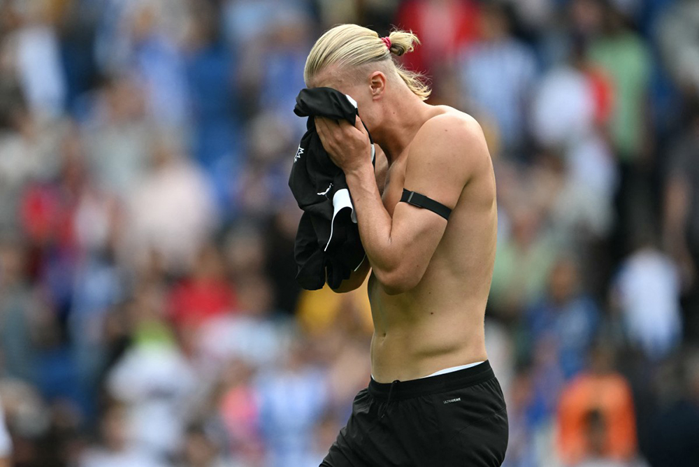 Manchester City's Norwegian striker #09 Erling Haaland reacts after the English Premier League football match between Brighton and Hove Albion and Manchester City at the American Express Community Stadium in Brighton, southern England on August 31, 2025. Brighton won the game 2-1.