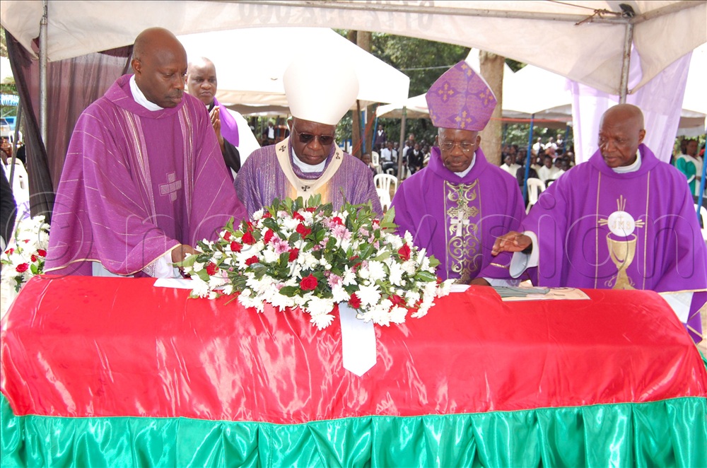 The Prelates, L-R: Msgr. Rogers Kabuye, Archbishop Paul Ssemogerere, archbishop Dr. Augustine Kasujja and Fr. Pius Male Ssentumbwe laying a wreath on the casket bearing the remains of Fr. Viatori Muvunyi during the requiem mass at Kisubi Minor Seminary on Entebbe Road, in Wakiso district on Tuesday, June 23, 2026.