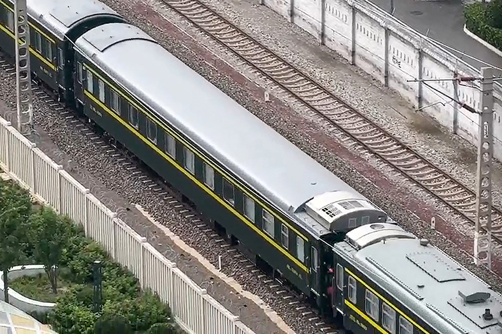 This frame grab made from AFPTV video footage taken on September 2, 2025 shows a train believed to be carrying leader Kim Jong Un in Beijing. The train, flying North Korea flags, was seen by AFP journalists approaching Beijing Railway Station on September 2 ahead of a massive military parade the following day. (Photo by Michael ZHANG / AFPTV / AFP)