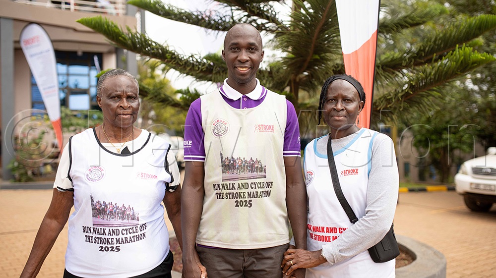 The Principal Senior Physiotherapist at Stroke Rehabilitation Centre in Wampewo Gayaza a city suburb, Ibrahim Bukenya, poses for a photo with stroke survivors. (Credit: Agnes Kyotalengerire)