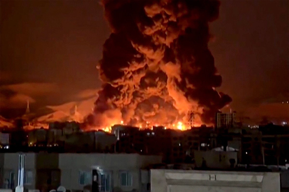 This video grab taken from UGC images posted on social media on March 7 and 8, 2026 shows fire erupting at an oil depot in Iran's capital Tehran. (Photo by UGC / AFP)