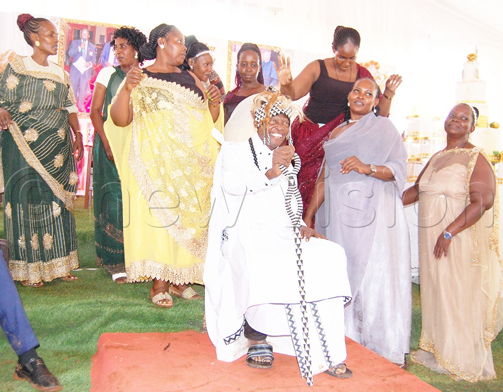 Fr Expedito Kakuba Kapia (sitting on a stool) with some of the members of his extended family during the function. (Photo by Mathias Mazinga)