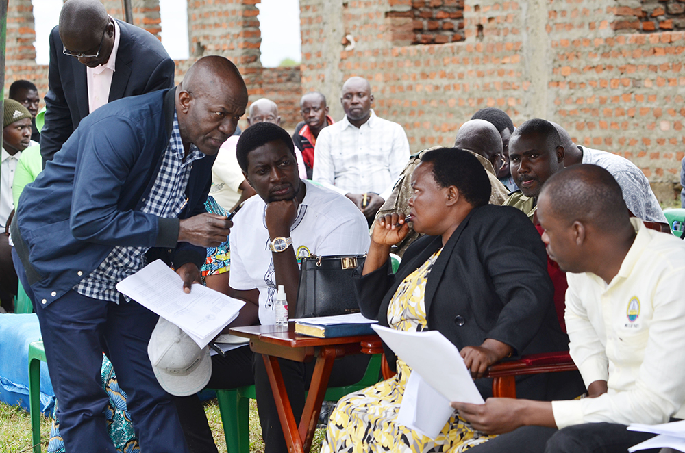 The Prime Minister Rt. Hon. Robinah Nabbanja consulting the PS OPM Mr Alex Kakooza during the meeting with the flood affected persons in Rwangara, Ntoroko district. (Courtesy)