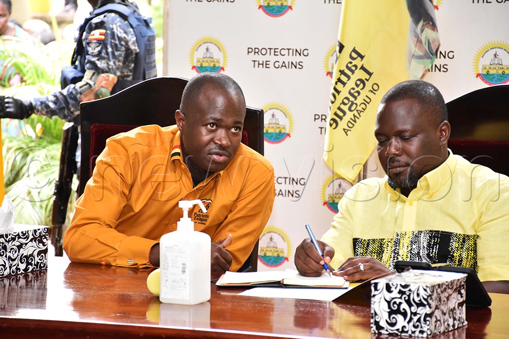 David Kabanda, the secretary general of Patrotic League of Uganda (PLU) sharing a light moment with RIchard Todwong, the NRM secretary general at the party's secretariat. (Photo by Simon Peter Tumwine)