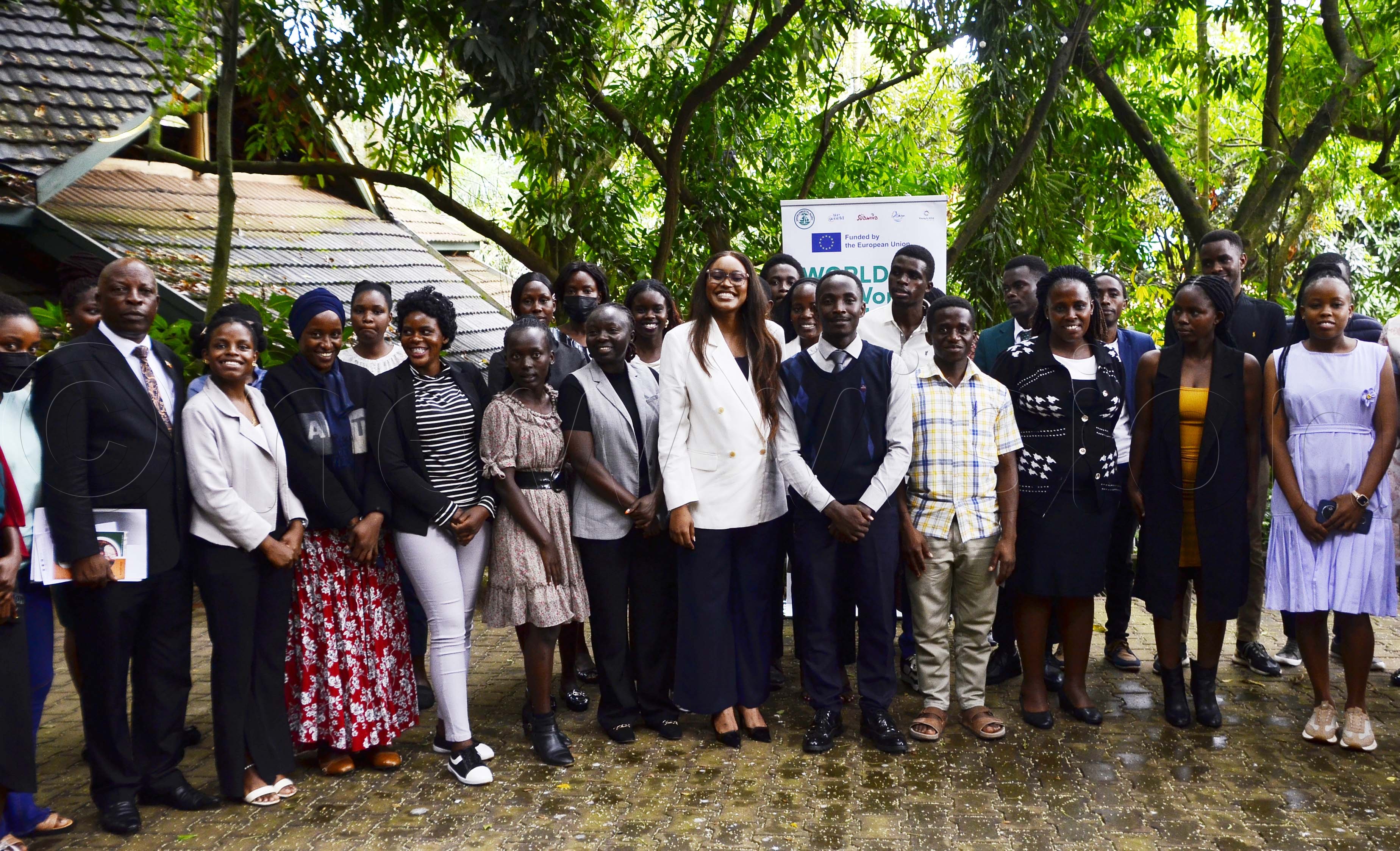 Sam Byibesho, Kisoro Municipality MP, Elma Kapel Challa, Northern Uganda youth MP poses for a photo with some of the youth during the validation and dissemination meeting of international youth manifesto at Forest Cottages Naguru on 28th May 2026. (Credit: Juliet Kasirye)