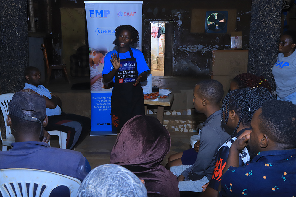 A Family Medical Point health worker talking to the locals of Nakiwogo fishing community in Entebbe Municipality during their health camp. (Credit: FMP)