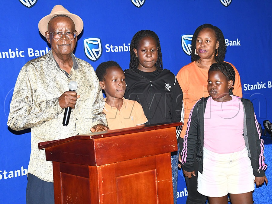 The late Henry Kamuntu family pose besides their grand father Ephraim Kamuntu at Kitante. Photo by Michael Nsubuga