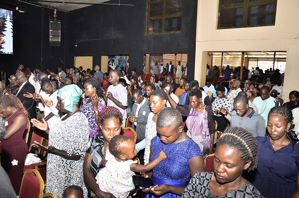 Christians pray during Christmas Church service at Victory Christian Church Ndeeba Kampala on Dec. 25, 2025. (Photo by Ronnie Kijjambu)