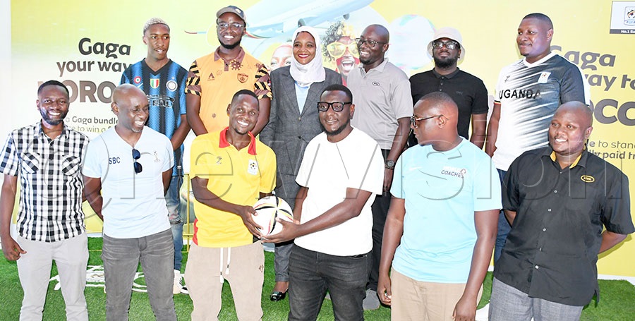 Uganda Cranes fans and Almuni team captains pose with MTN's JP Okwi (3rd right-back) , FUFA second vice president Dr. Azah Taibu (2nd left-back), Cranes player Moses Aliro (3rd left-front) and MTN's Martin Mwesige (right) during the launch of the ‘Gaga your way to Morocco’ fans promotion that will see MTN send 50 fans to cheer on the team in Morocco, at FUFA Kadiba stadium. Photo by Michael Nsubuga