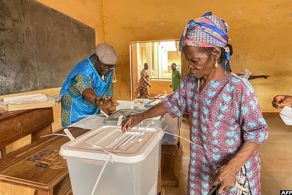 A voter casts her ballot at a polling station in Bangui on December 28, 2025 during Central African Republic's presidential election.