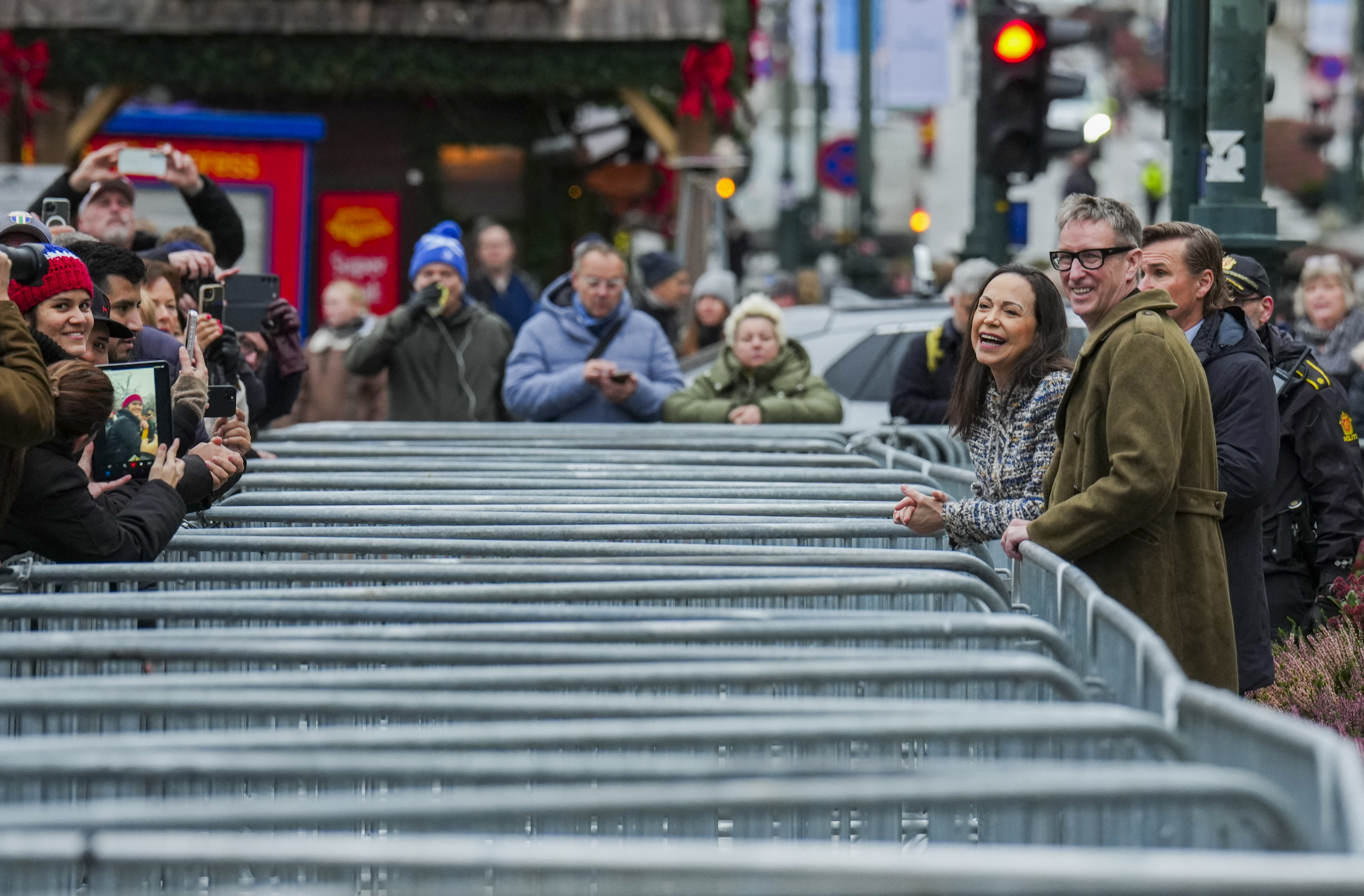 Nobel Peace Prize 2025 laureate Venezuelan opposition leader Maria Corina Machado (2nd R) stands next to the Deputy Leader of the Norwegian Nobel Committee Asle Toje (R) in front of the Grand Hotel in Oslo, Norway, after an audience at the Royal Palace.