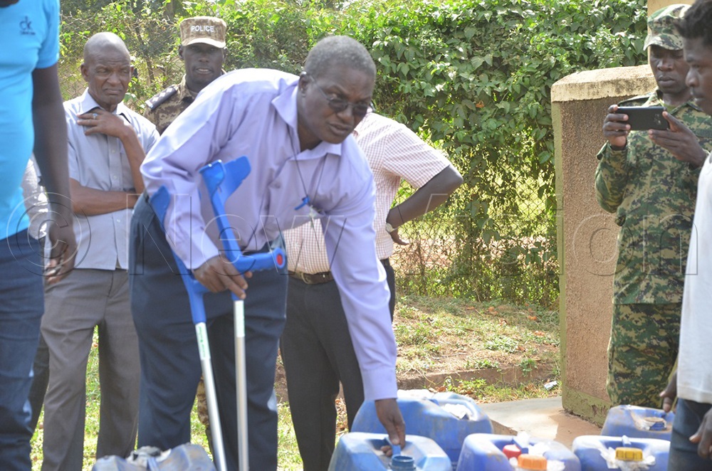 Ass. RDC Moroto Mark Aol Musooka presides over the destruction of 368 jerricans of waragi confiscated from traders a week ago. (Photo by Olandason Wanyama)