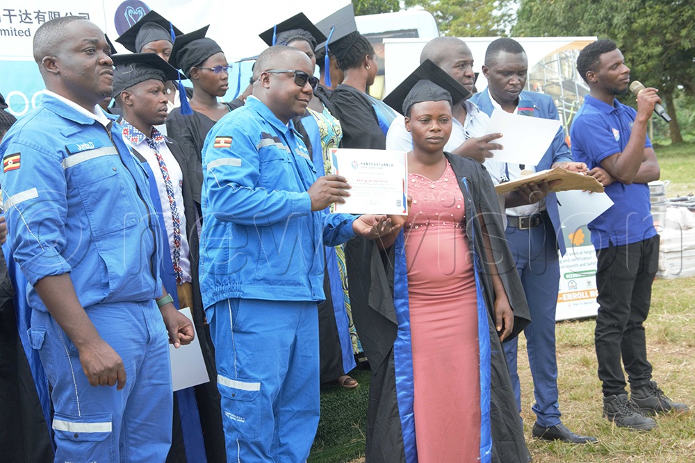 CNOOC officials handing over certificates to Kemigisa Kunihura, one of the beneficiaries of the training. (Credit: Peter Abaanabasazi)