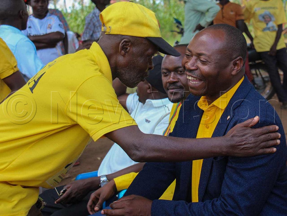 Excited Paddy Kisembo, NRM flag bearer (right), being greeted by an elderly man during the campaign. (Photo by Peter Abaanabasazi)