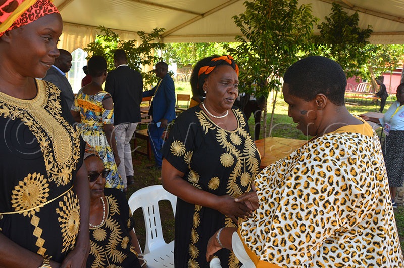 Mary Karoro Okurut greeting the state minister for disability, Grace Asamo, during the burial of Onapito Ekomoloit in Amuria last year. (Photo by Godfrey Ojore)